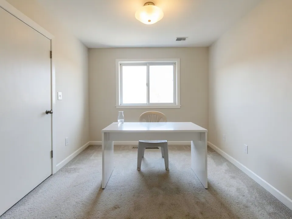 Plain spare room used as a basic office