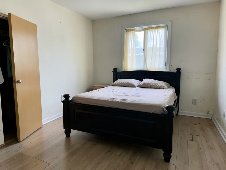 Plain bedroom with a dark bed frame