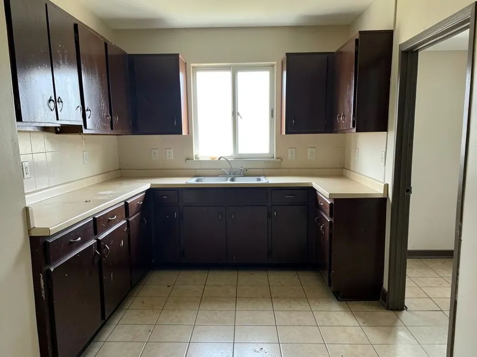Dated kitchen with dark brown cabinets