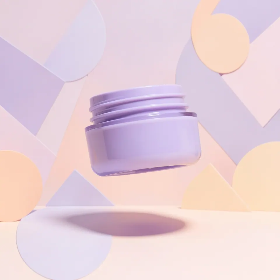 Lavender cosmetic jar floating above pastel geometric shapes