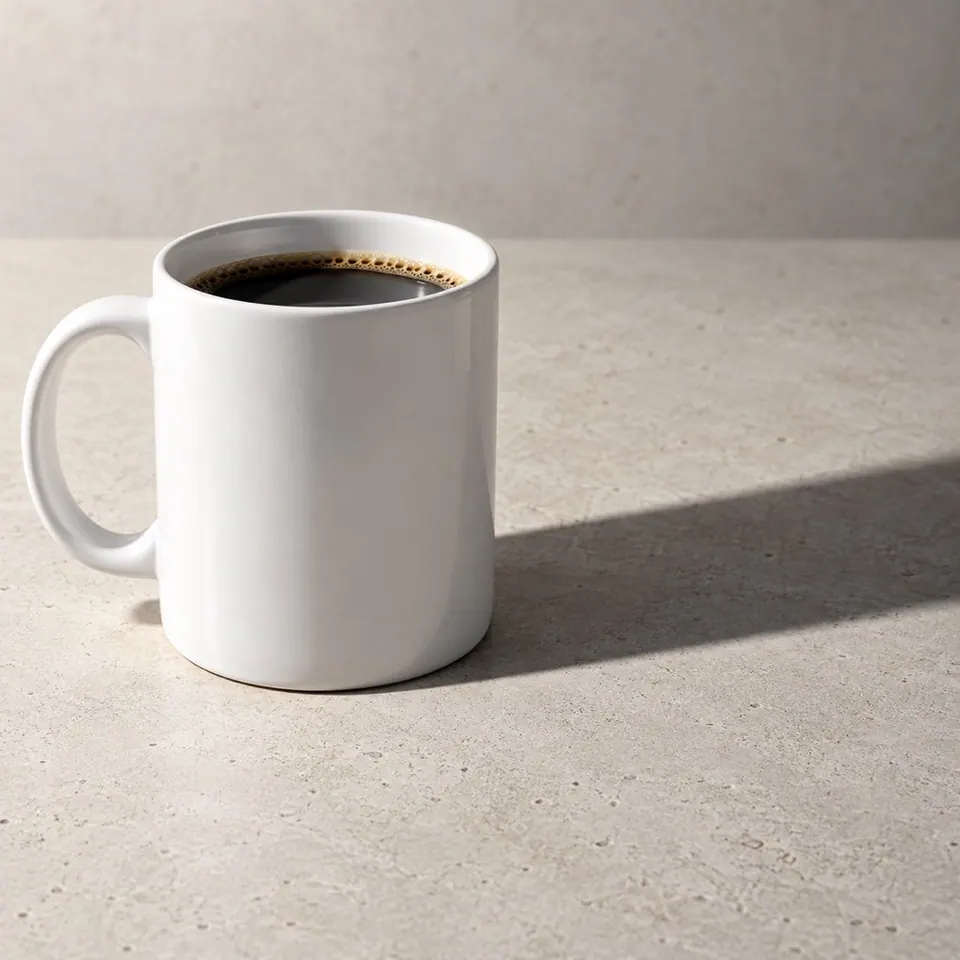 Coffee mug casting a dark shadow across a tabletop